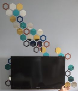 hexagonal mirrors on TV feature wall