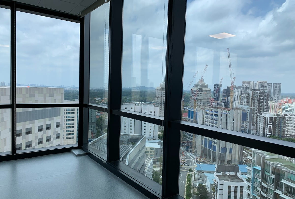 City view through large glass windows in a high-rise building
