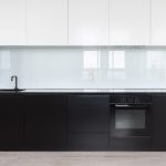 Modern kitchen with glass backsplash and minimalist design