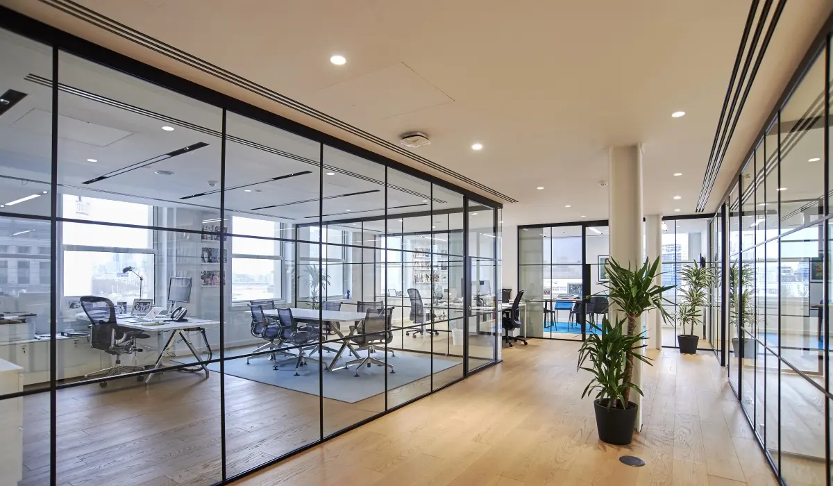 Modern office with glass partition walls and meeting rooms