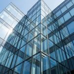 Modern glass building facade with reflective panels