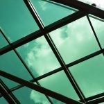 Glass roof panels with sky visible through structure