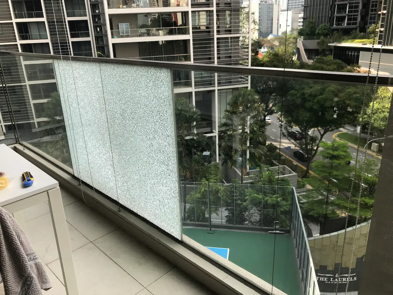 Shattered Balcony glass railing with a frosted privacy panel
