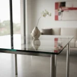Modern glass table with metal legs in a living space