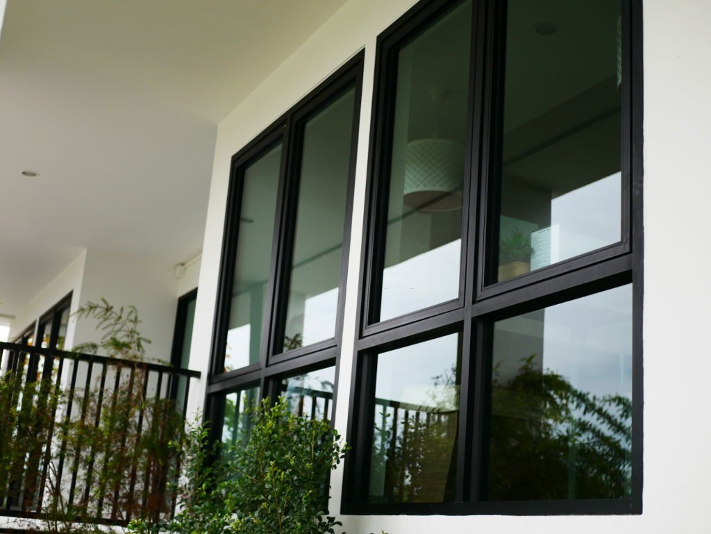 Modern house exterior with black-framed glass windows