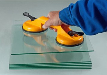 Hand lifting stacked glass panels with a suction cup tool