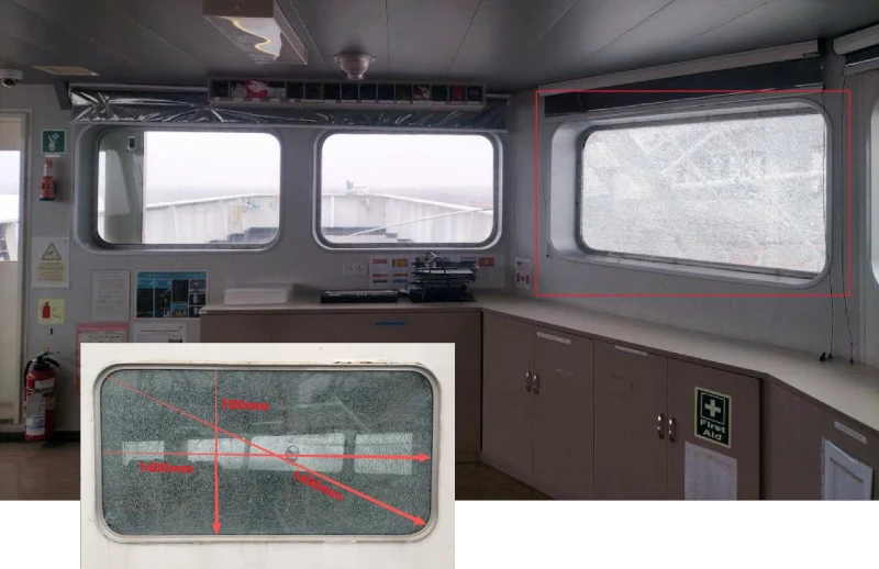 Cracked glass window inside a ship control room